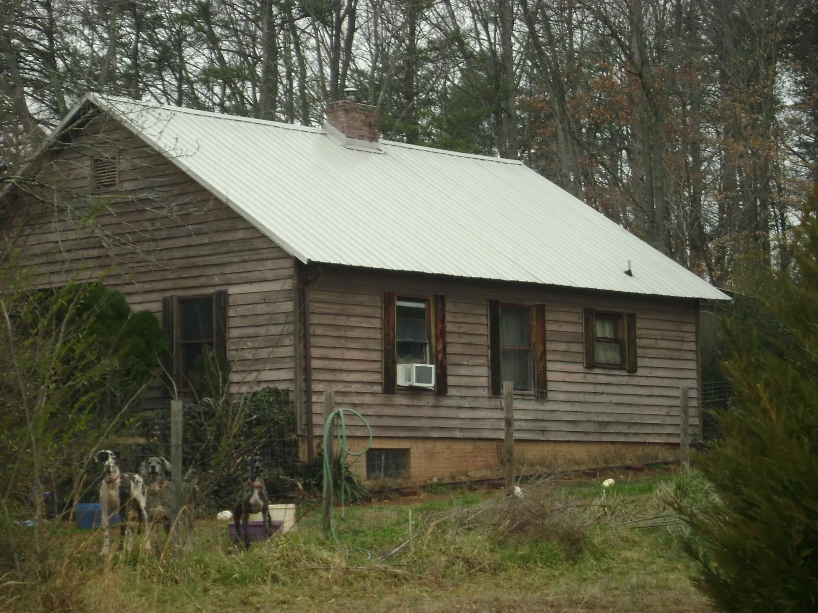 White metal roof on an old wood sided farmhouse, from a Metal Roof Installation job in Gypsum
